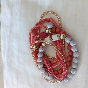 Coral, gold and gray stretch beaded bracelets.